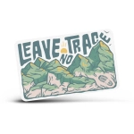 A rectangular sticker featuring green mountains and the phrase "Leave No Trace" in bold lettering.