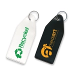 A vinyl key tag in white and black, featuring two logos and a keyring for attachment.