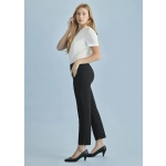 A woman poses in black slim leg pants with a fitted white top against a light blue background.