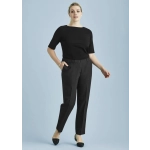 A woman in a black top and black ultra comfort waist pants poses against a light blue background. The pants feature a waistband and pockets.