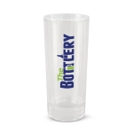A clear glass shot glass with a printed logo that reads "The Bottlery" in bold letters.