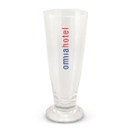 A clear beer glass with a tall, slender design and a base, featuring a logo in red and blue.