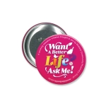 A round, 90mm pink button badge with a silver backing and an attached pin. It features colourful text and a logo.