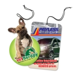 A car air freshener featuring a dog graphic, circular shape, predominantly green, with a tag and string for hanging.