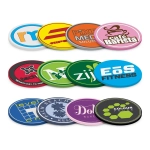 A collection of colorful PVC coasters featuring various business logos and designs.