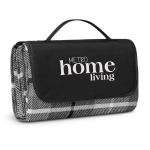 A folded picnic blanket with a black carrying handle, featuring a grey and white pattern and a logo.