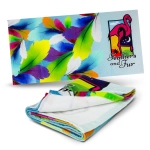A colourful beach towel featuring vibrant feathers and a flamingo design. It has a logo on one side.