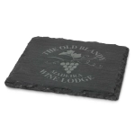 A single slate coaster in dark grey with a grapevine design and a logo. Edges are textured and natural.