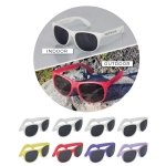 A variety of Malibu Basic Sunglasses in white, red, yellow, and purple on a grey background and rocky surface.