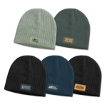 A collection of Nebraska cable knit beanies in green, dark green, teal, and black, featuring various patches.