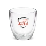 A double wall glass in clear with a logo, featuring a sleek, modern design. Suitable for various beverages.