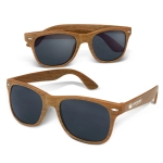 A pair of brown wooden sunglasses with dark lenses and a logo on the arm.