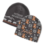 A grey knitted beanie featuring a mountain and bear design, and another with fox illustrations and a logo.