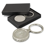 A drink bottle opener key ring in silver, presented in a black box, featuring an engraved logo.
