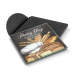 A square glass coaster with a pastry shop illustration, featuring brown and white tones, in a black box.
