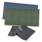 Three luxurious towels in blue, green, and grey, featuring textured patterns and a logo.
