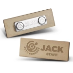 A wooden badge with a light wood finish, featuring two magnetic components and a logo.