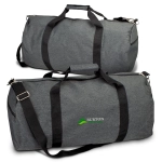 A grey duffle bag with black straps and a branding logo. The bag features a large zippered compartment.
