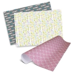 Personalised gift wrapping paper in pink and green patterns, featuring various decorative designs and a logo.