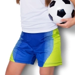 Custom women's sports shorts in blue and lime green, featuring a logo, paired with a soccer ball.