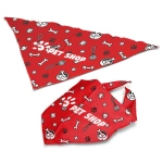 A large red pet bandana featuring playful patterns of bones, paw prints, and toys, with a logo.