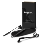 A candle accessory set featuring a black candle snuffer, wick trimmer, and dipper, presented in a sleek black box.