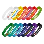 A collection of silicone wristbands in various colours, featuring different logos and text designs.