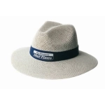 A cream-coloured straw hat with a navy band and a logo, featuring a wide brim and a textured design.