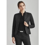A women's black comfort wool stretch short jacket with reverse lapel, styled with a black top and belted trousers.