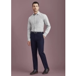 Men's slim fit flat front pants in navy, paired with a light grey shirt and black shoes. Features a logo on the waistband.