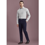A man wearing a light grey shirt and navy blue slim fit flat front pants, complemented by black shoes and a belt.