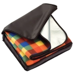 A picnic rug in a carry bag, featuring a colourful checker pattern and a reflective inner lining.