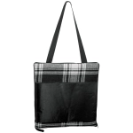 A black and white plaid picnic rug with a black carrying strap, featuring a large pocket on the back.