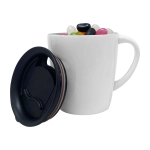 A white mug with a black lid filled with colourful jelly beans. The mug features a logo.