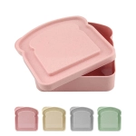 A bamboo sandwich box in a pink colour with a bread-shaped lid, alongside options in cream, grey, and green.