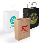 Three medium paper bags: one white with a logo, one brown with red text, and one black with a logo in yellow.