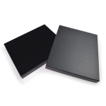 A black gift box with a textured finish, featuring a smooth lid and a sleek design, with a logo on the surface.