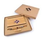 A bamboo notebook with a spiral binding and a silver pen, packaged in a brown cardboard gift box.