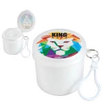 A colorful container with a lion graphic, holding a rolled-up poncho and featuring a keyring attachment.