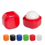 A red lip balm cube with a white balm top, alongside colour variations in black, orange, blue, green, and white.