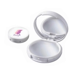 A compact lip gloss with a mirror, featuring a white case and a small circular lid, suitable for personal use.