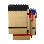 A set of recyclable paper jotter pads in brown, with black, red, and blue pens, featuring elastic bands and spirals.
