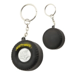 A black tyre-shaped key ring with a silver wheel design and a logo. Features a metal keychain attachment.