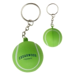 A green tennis ball key ring with white markings and a logo, designed as a stress relief item.