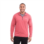 A man wearing a red quarter zip jumper with a logo on the chest, featuring a textured fabric design.