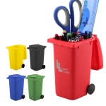 A red wheelie bin pen holder containing scissors, a ruler, and pens, alongside green, black, yellow, and blue bins.