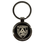 A gunmetal keychain featuring a circular design with a logo and a silver keyring attachment.