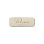 A rectangular wooden badge in light tan with a name engraved on the surface, featuring a subtle, polished finish.