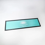 A bar runner featuring a turquoise colour with a black border and a logo design in the centre.
