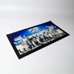 A rectangular bar runner featuring a black border with a group photo and blue background. Displays a logo.